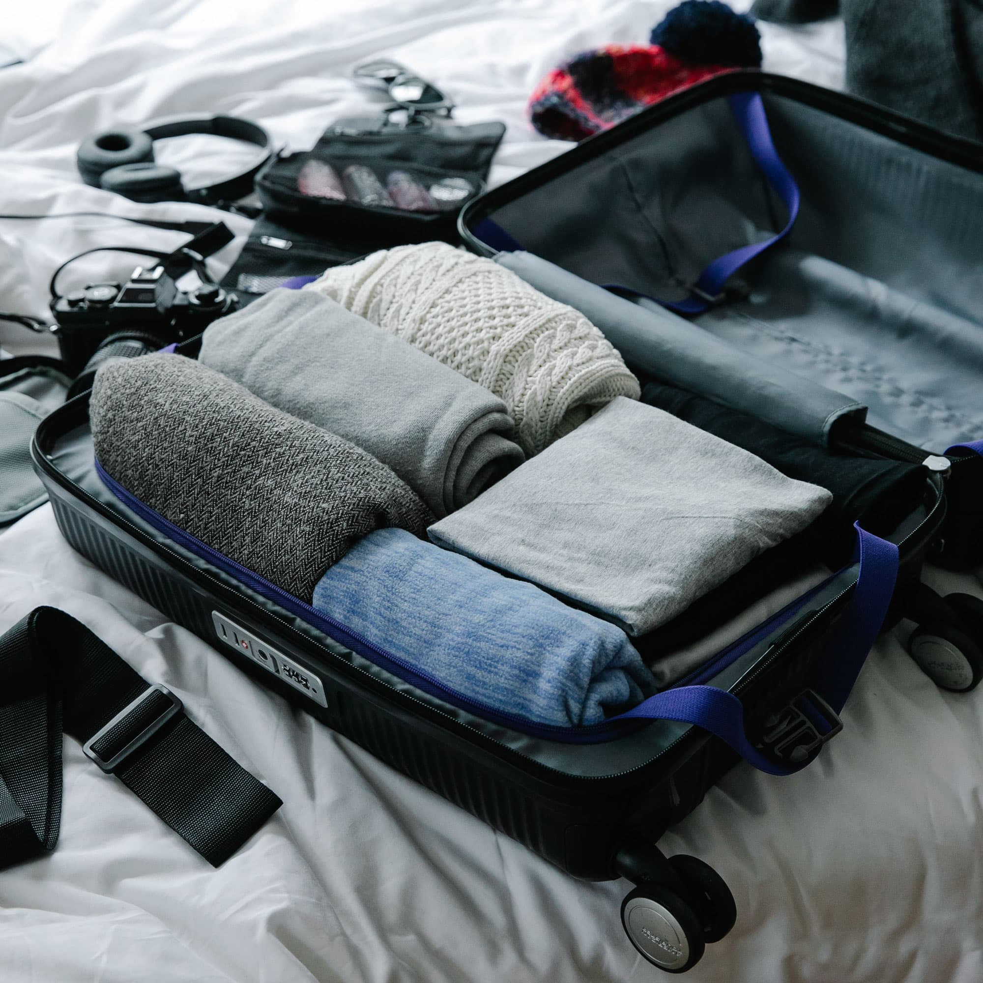 Open suitcase with packed clothes