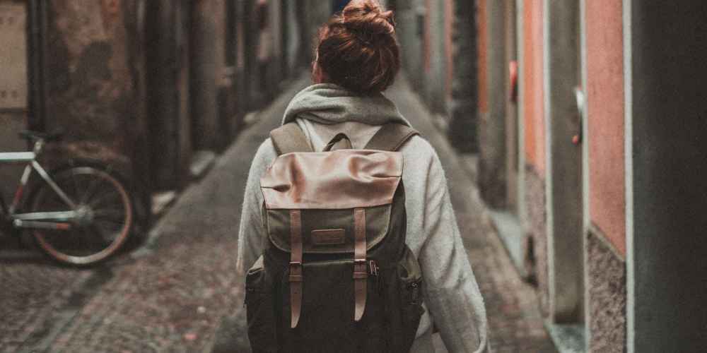 Solo traveler looking down alley