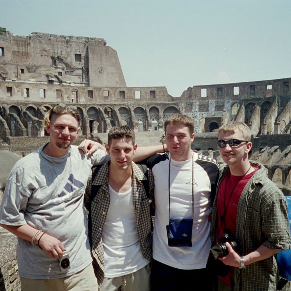 Four friends at the Colosseum in Rome
